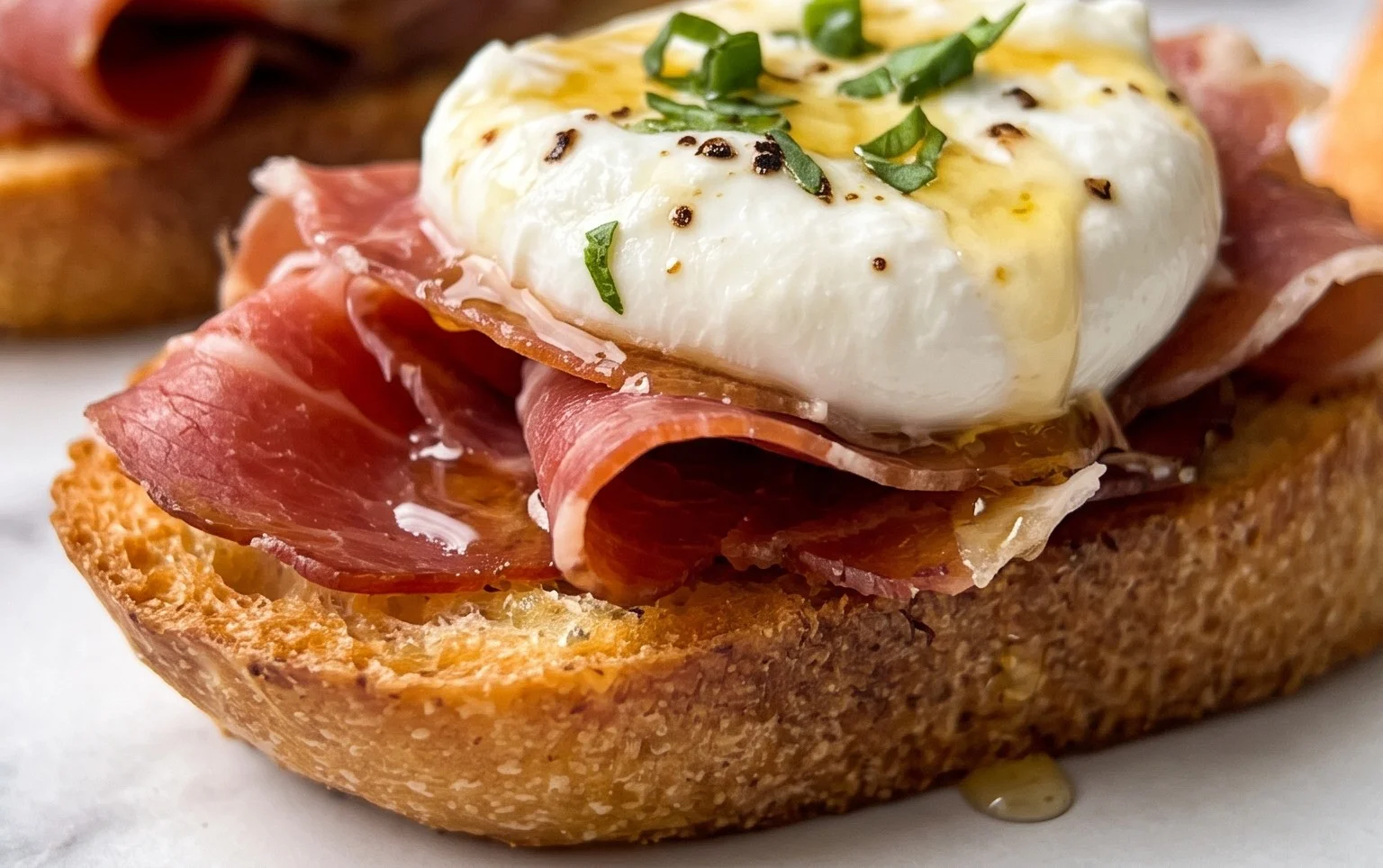 Beef Prosciutto Crostini with Burrata and Lemon Honey Drizzle